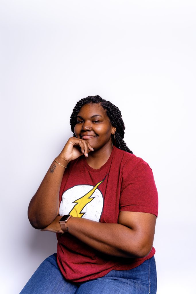 alexa owens, founder of alexa's email studio in red t shirt with flash symbol